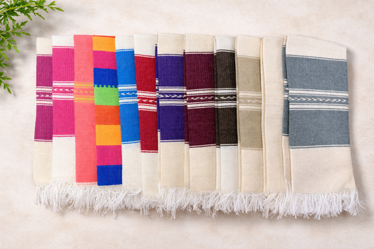 Set of colorful woven fabrics with fringes on a light background
